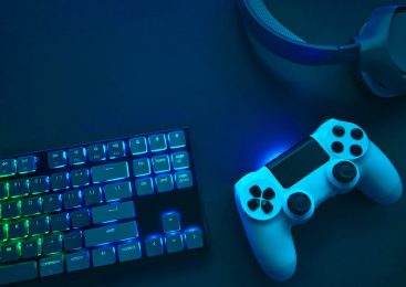 Top down view of colorful illuminated gaming accessories laying on table.